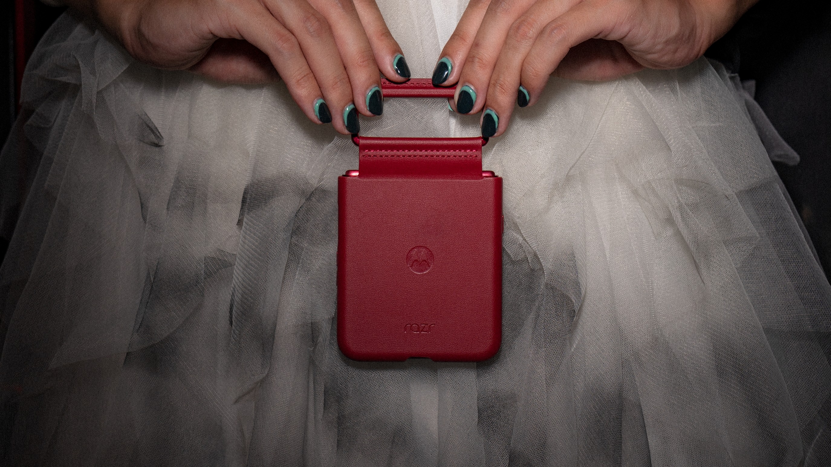 Razr Ultra 2025 in a red case held by two hands