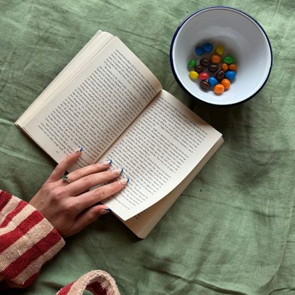 Self care advent calendar: Health writer Georgia reading and in bed practicing self care during December