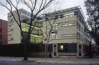Exterior view of the gated South African Embassy and nearby trees during the day