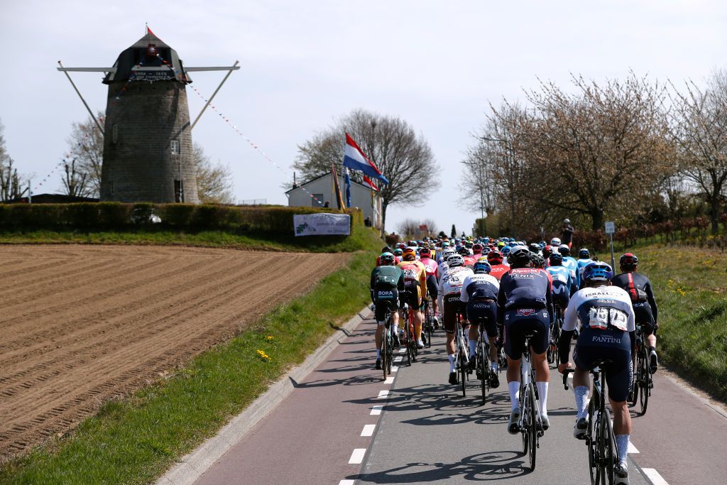 BERG NETHERLANDS APRIL 18 The peloton during the 55th Amstel Gold Race 2021 Mens Elite a 2167km race from Valkenburg to Berg en Terblijt Windmill Flag Landscape Amstelgoldrace amstelgoldrace on April 18 2021 in Berg Netherlands Photo by Bas CzerwinskiGetty Images