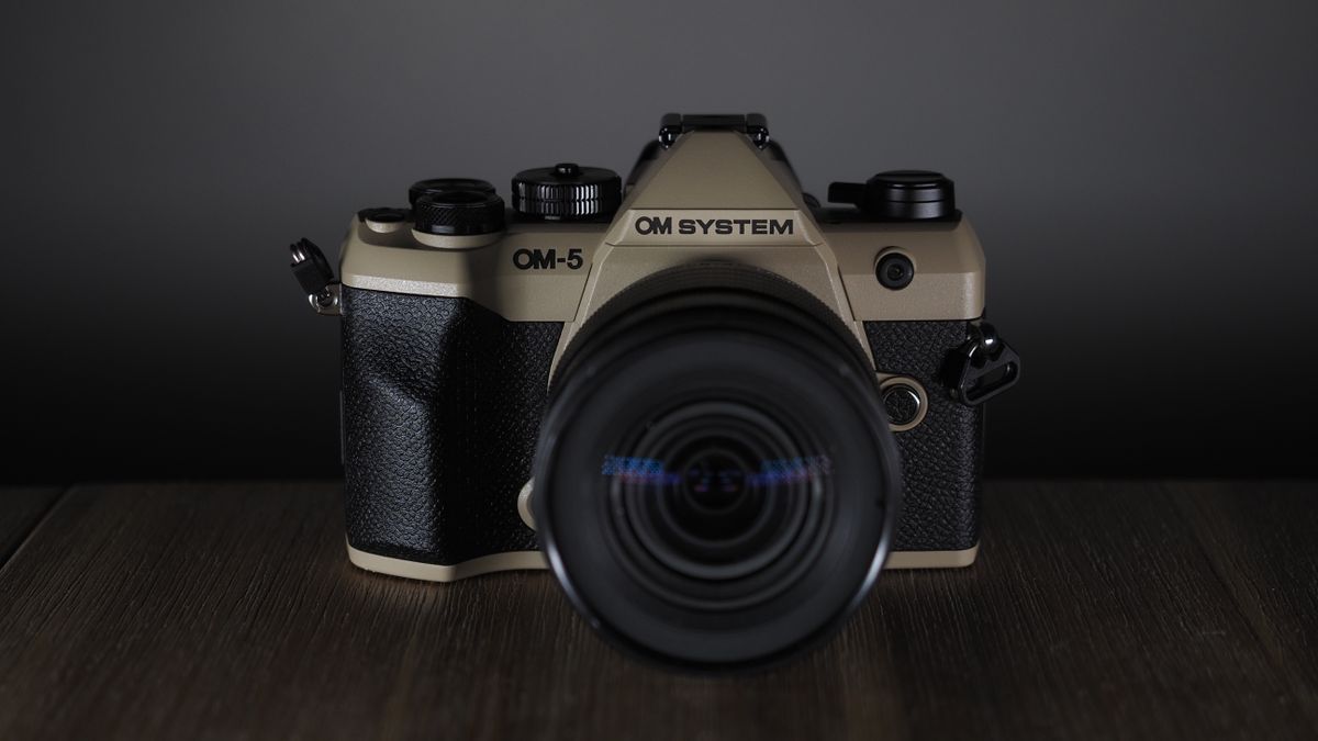 OM System OM-5 Mark II on a wooden surface with an Olympus M.Zuiko 12-45mm lens