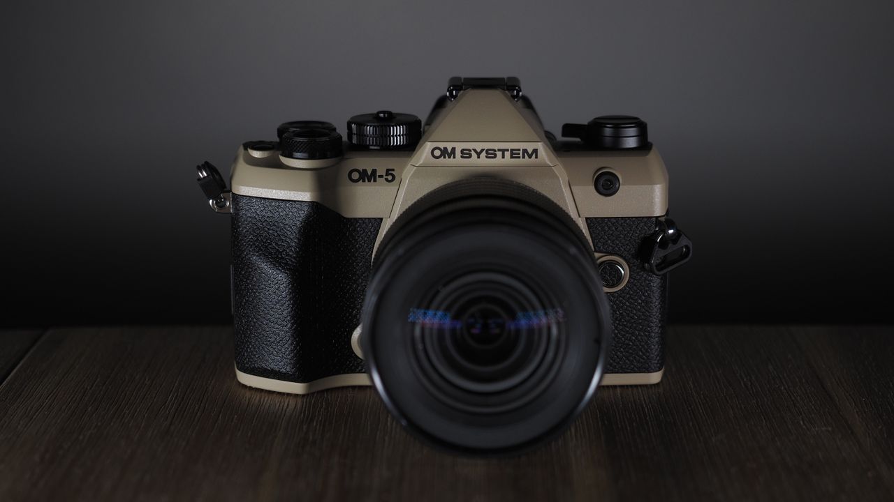 OM System OM-5 Mark II on a wooden surface with an Olympus M.Zuiko 12-45mm lens