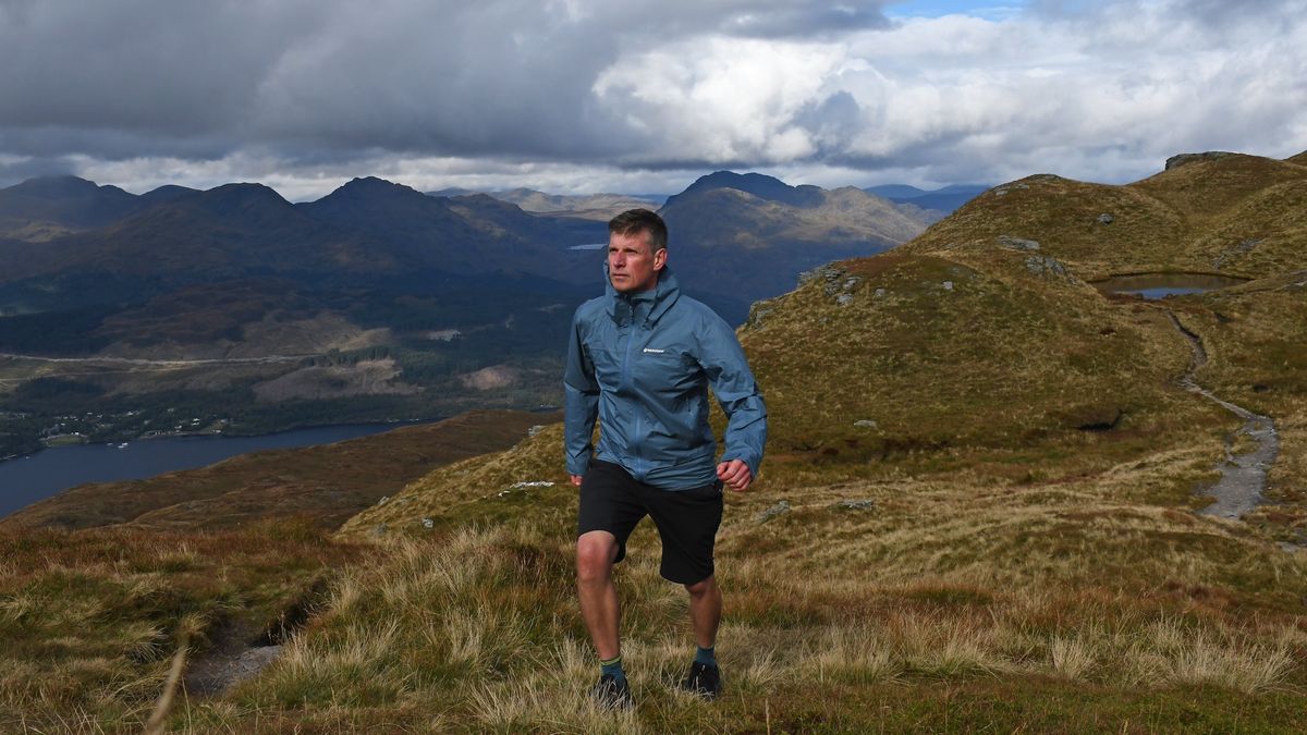 Man wearing Montane Cetus Lite Waterproof Jacket while hiking in Scotland, Ben Lomond