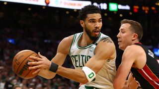 Jayson Tatum #0 of the Boston Celtics looks to pass against Duncan Robinson #55 of the Miami Heat