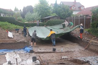 Archaeologists protect the dig