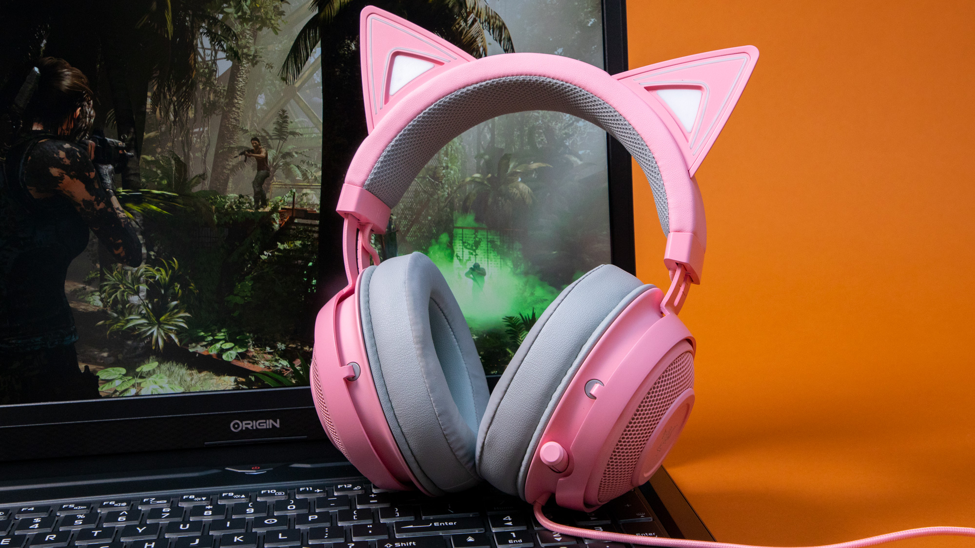 razer kraken kitty edition on a gaming laptop against an orange background