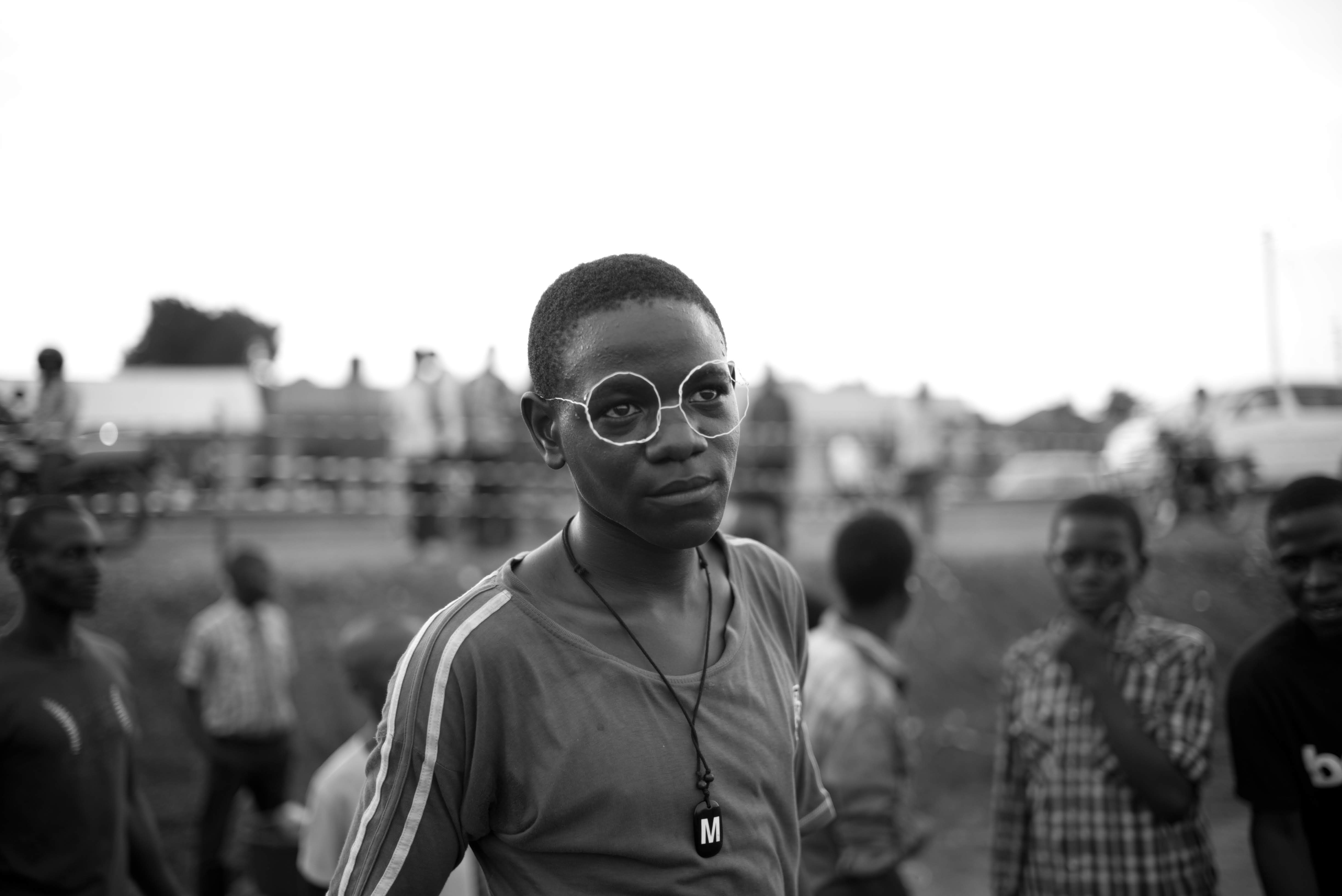 Young man with handmade frames in Kyebando, Uganda, April 2018