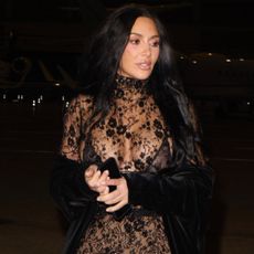 Kim Kardashian was spotted in Paris wearing a lace naked dress and matching velvet cape
