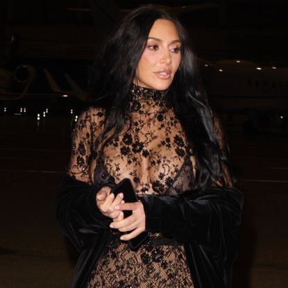 Kim Kardashian was spotted in Paris wearing a lace naked dress and matching velvet cape