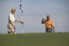 Older couple playing golf