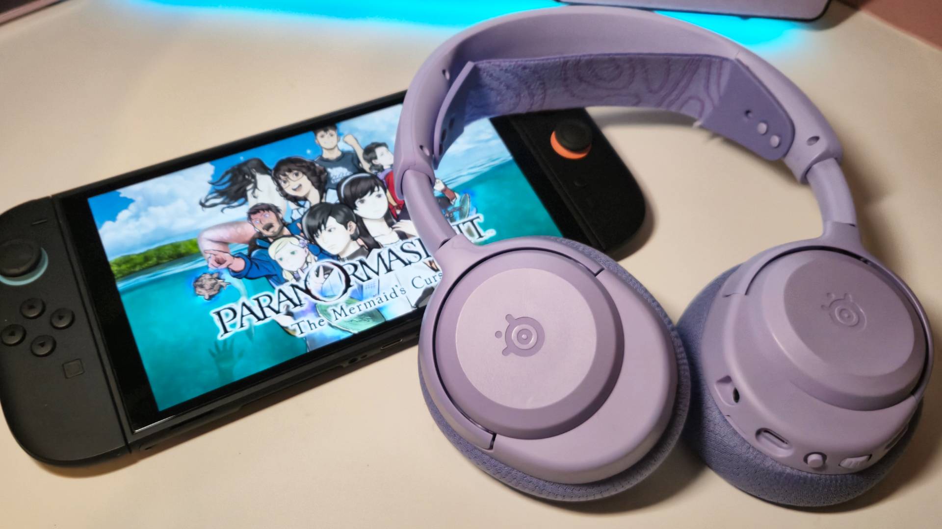 Photo of the Arctis Nova 3 Wireless headset sitting on a Switch 2 showing the Mermaid's Curse.