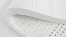 A foam mattress topper on a white background