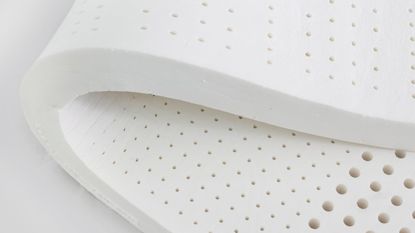 A foam mattress topper on a white background 