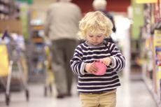 Toddler looking in purse in shop