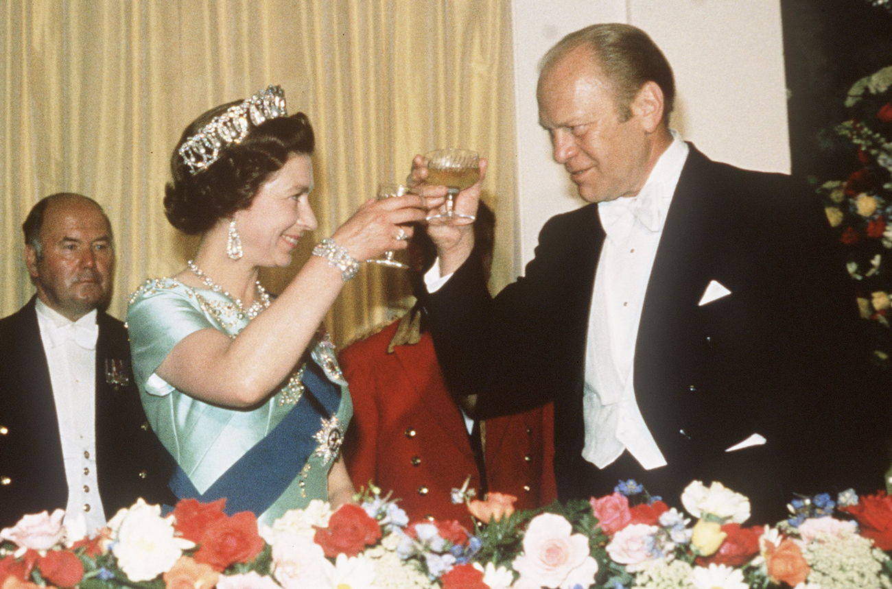 Queen Elizabeth II raises a glass of Champagne with US President Ford