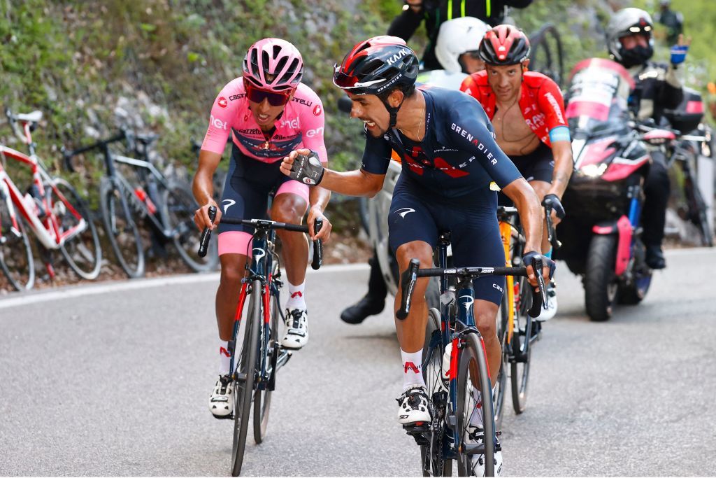 Dani Martínez (Ineos Grenadiers) wills his teammate Egan Bernal on as they tackle the steep slopes of Sega di Ala