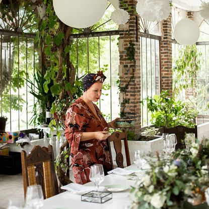 lady with dining table and chairs and dinner platters