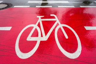 White painted bike on red bike path