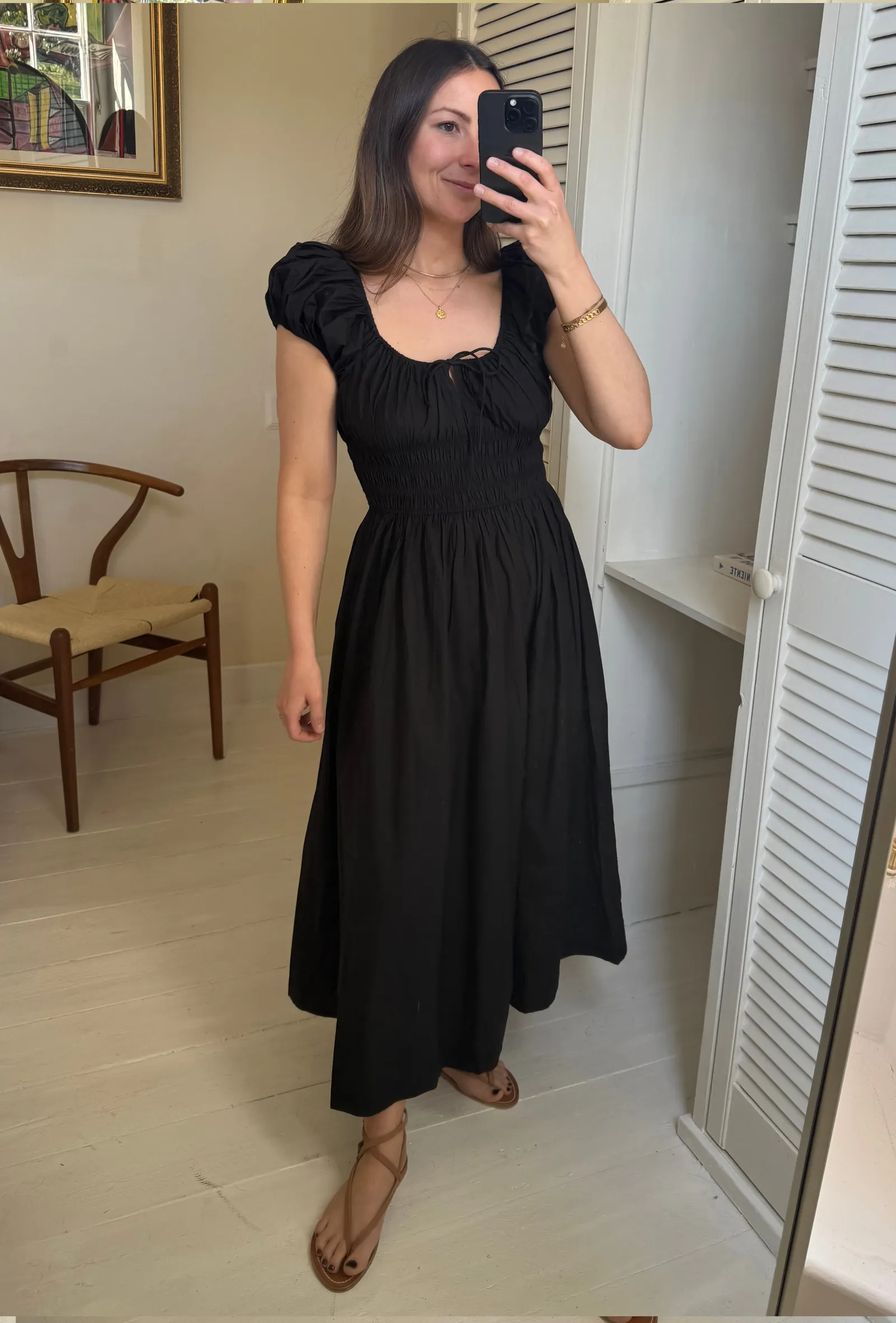 Emily Dawes wears K Jacques leather sandals popular for summer 2026 with a black doen dress