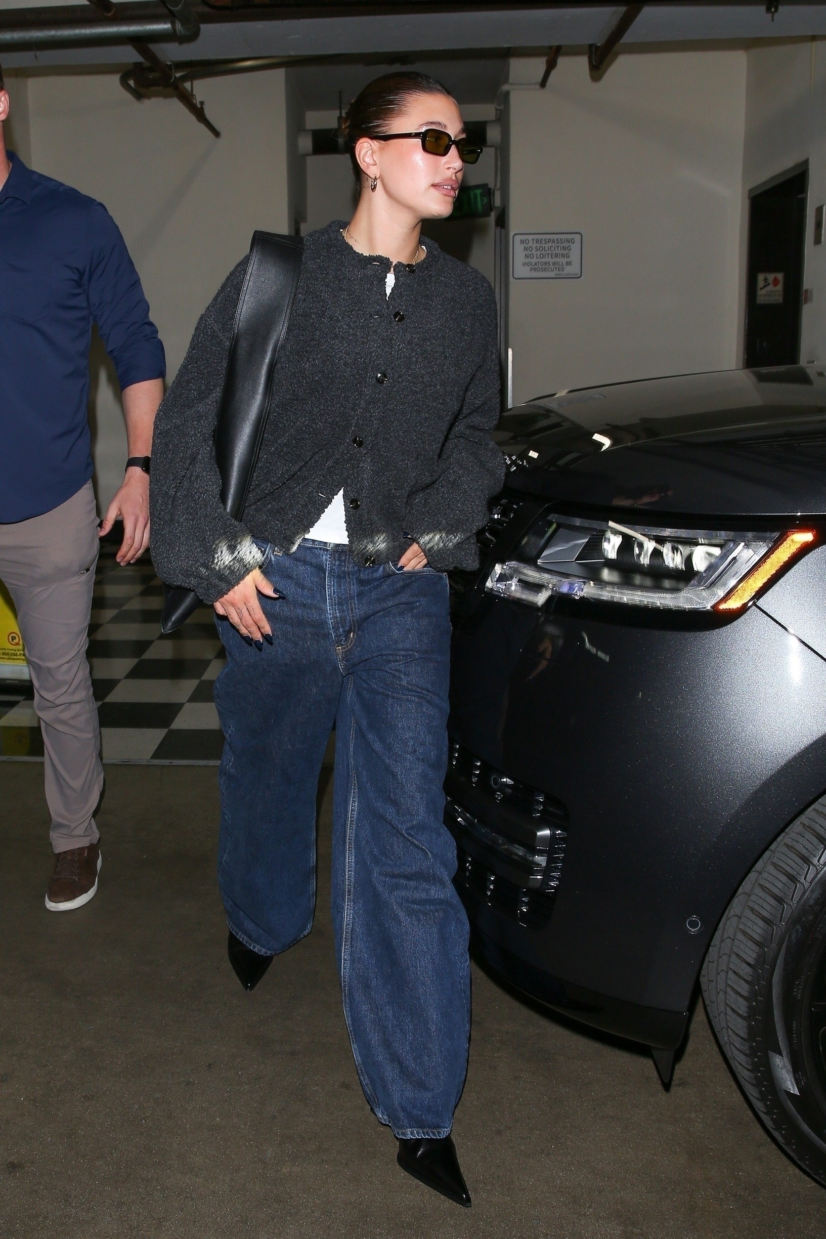 Hailey Bieber wears Agolde Jeans while out to dinner in Los Angeles. She pairs the indigo-coloured trousers with a white t-shirt and grey cardigan.