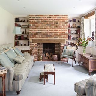 living room with brick fireplace