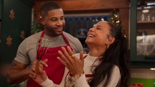 Devale Ellis as Teddy and Christina Milian as Layla joking around together in Meet Me Next Christmas.