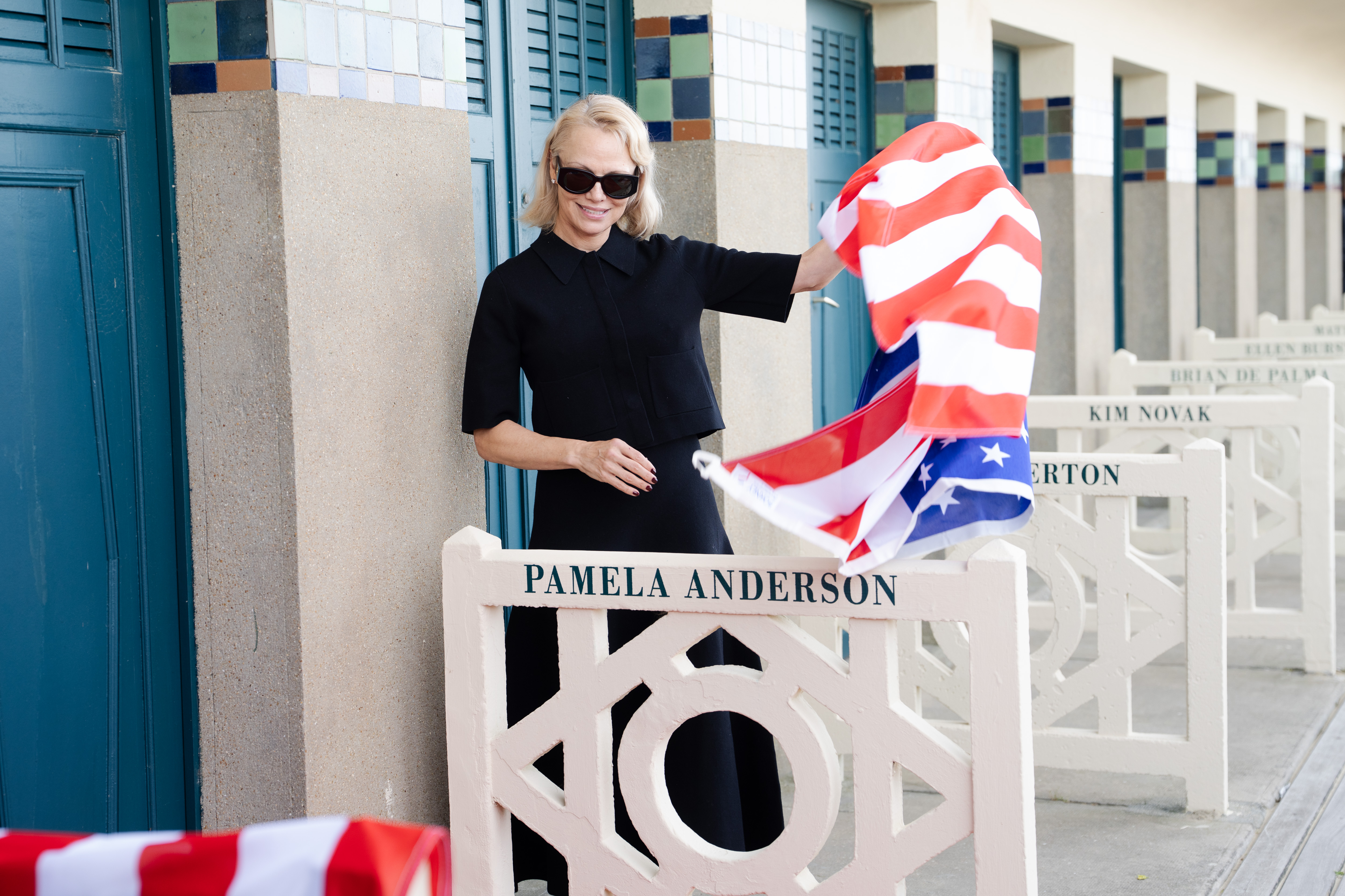 Pamela Anderson waving an American flag