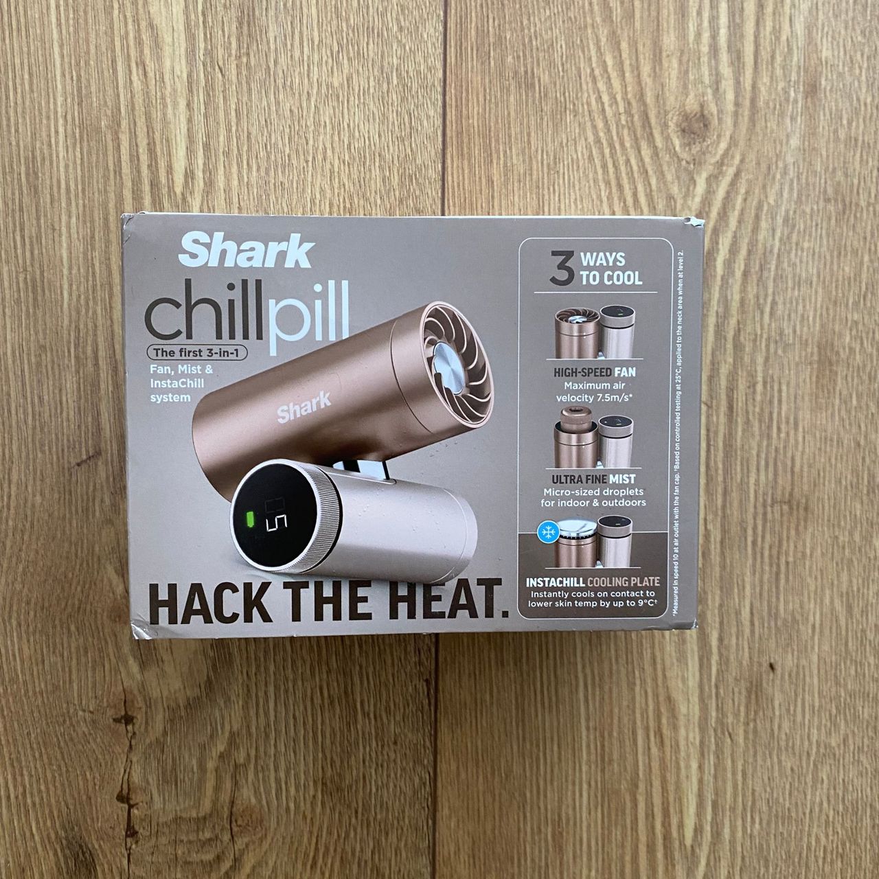Closed packaging of the Shark ChillPill on a wood-look floor