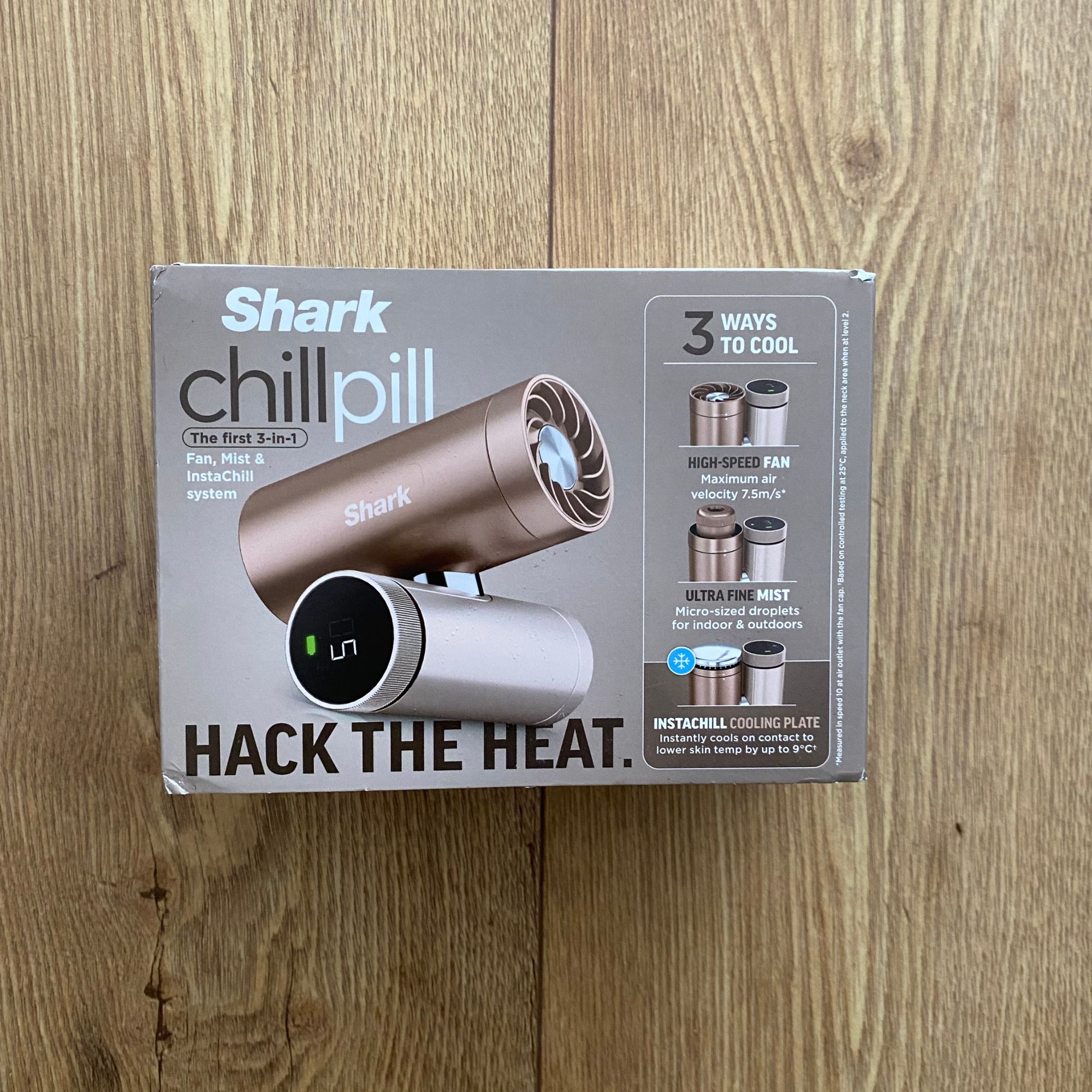Closed packaging of the Shark ChillPill on a wood-look floor