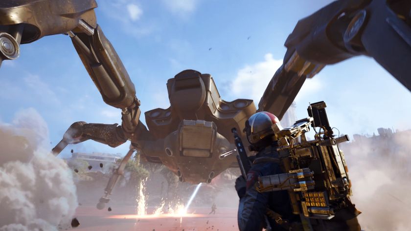 Arc Raiders Queen blaze grenade traps: A player reloading their gun while fighting a Queen at the base of the dam wall in Dam Battlegrounds, as it kicks up sand and fires a laser at another player in the distance.