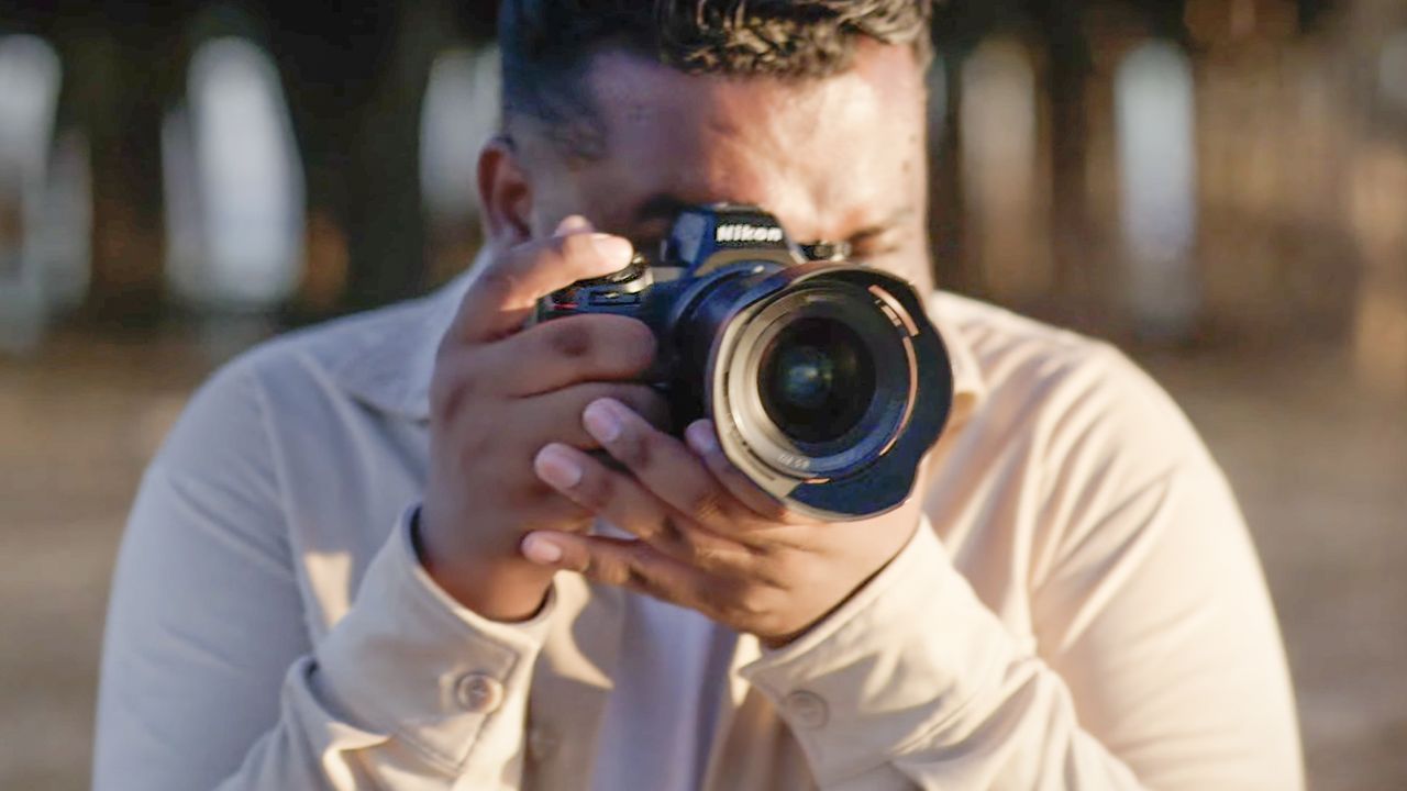 Male photographer using the Nikon Z6 III on a beach