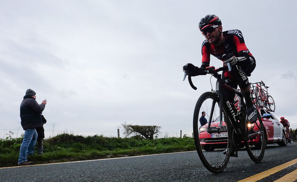 A spectator takes a picture as a rider competes in stage three of the Tour de Yorkshire