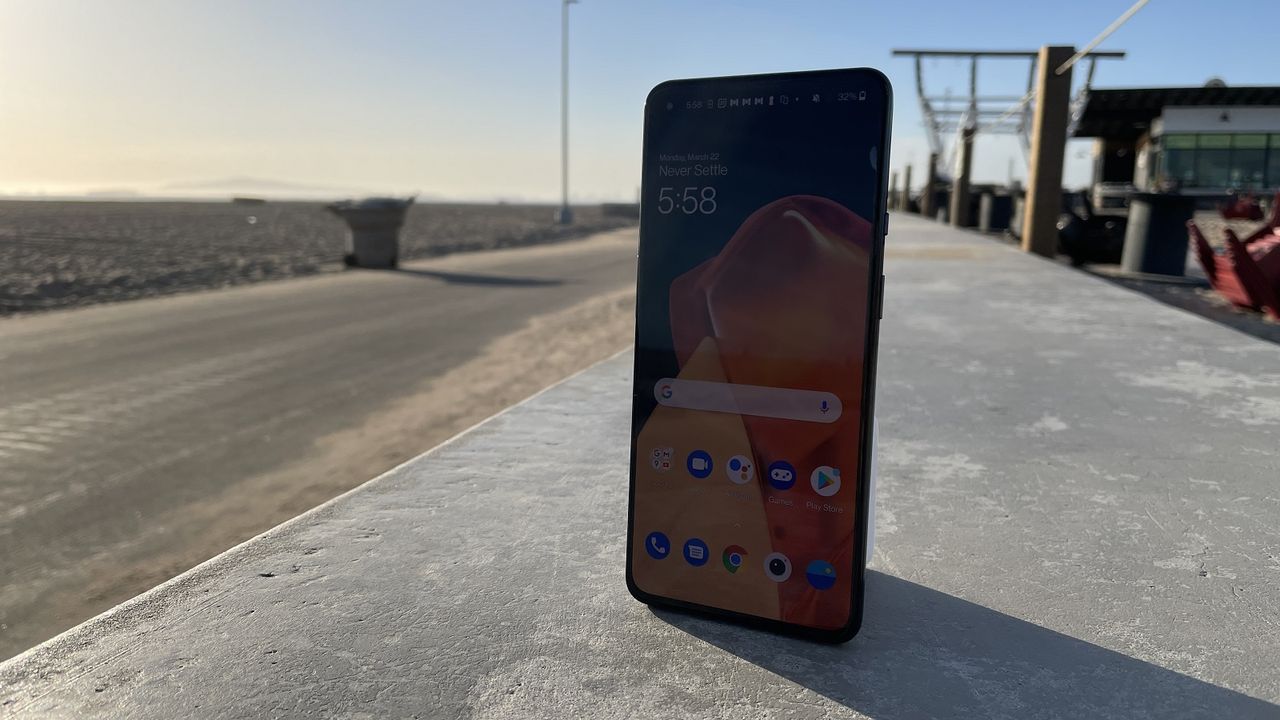 A OnePlus 9 from the front, by a road