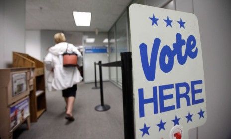 A sign directs people where to cast their vote, during early voting at the Wood County Court House in Bowling Green, Ohio, on Oct. 2.