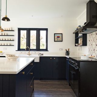 White kitchen with black cabinets and island unit