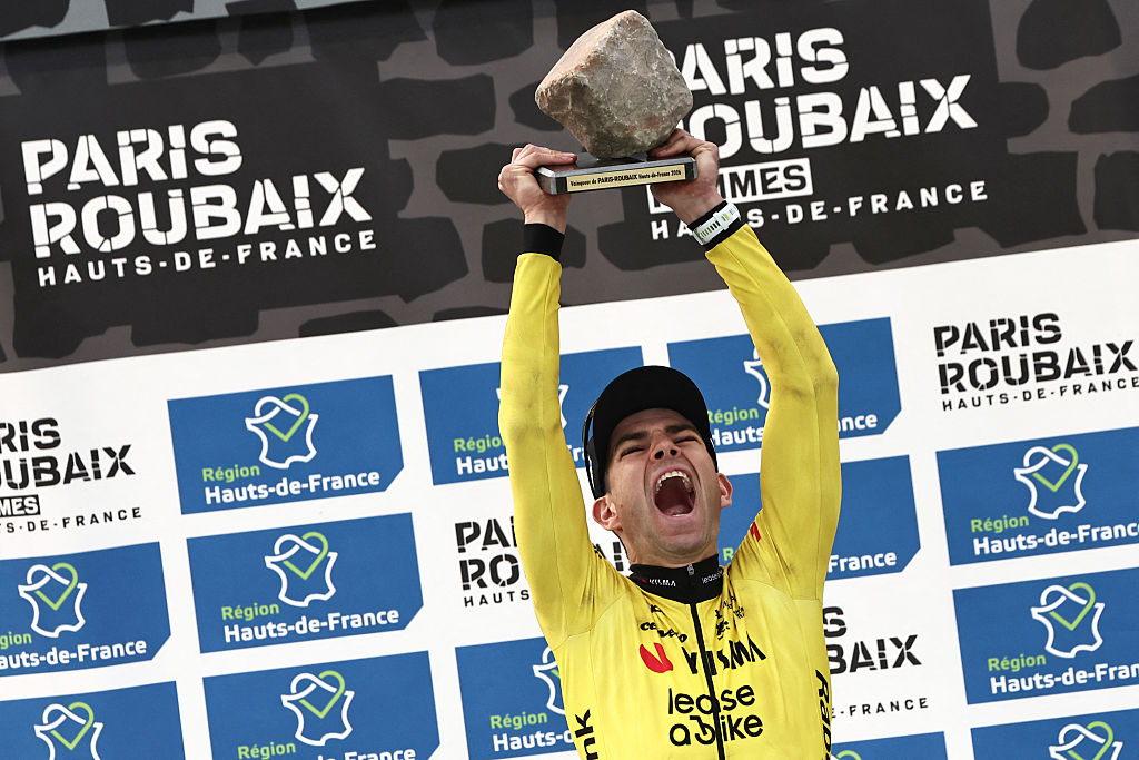 Winner Team Visma - Lease a Bike's Belgian rider Wout van Aert celebrates on the podium of the 123rd edition of the Paris-Roubaix 