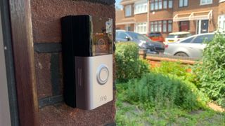 Ring Battery Video Doorbell Plus mounted on a brick wall