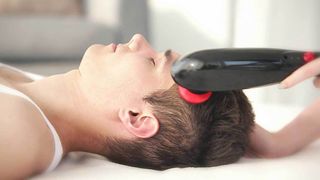 Pado PureWave CM-07 Massager review: A person enjoys a head massage using the Pado PureWave