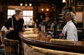 Dawn Taylor talks to Naomi Walters behind the bar of the Woolpack