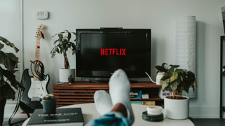 Netflix logo on a screen in front of a table