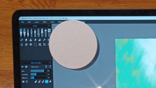 Microsoft Surface Dial review; a small silver gadget is attached to a display