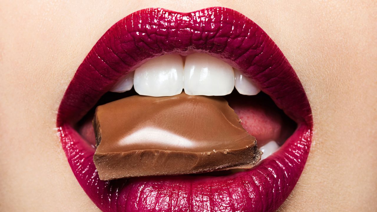 Beautiful female lips with chocolate