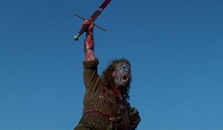 Braveheart Mel Gibson hoists a bloody sword and shouts