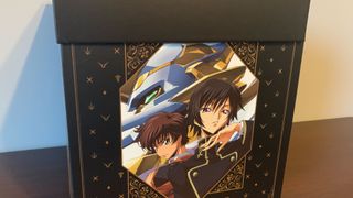 The Code Geass collector's edition box, seen from the side, sitting on a wooden surface