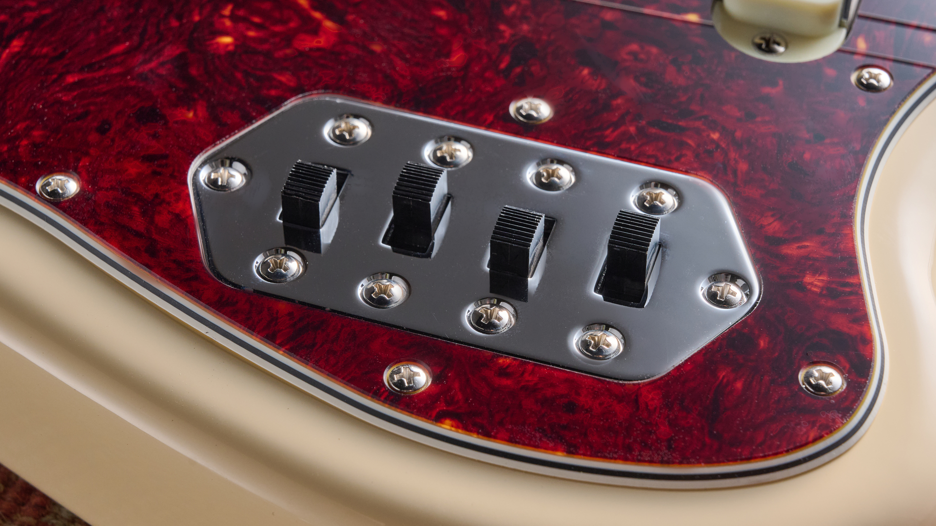 Fender Vintera III Early '60s Bass VI in Olympic ‍White with ‌red tortoiseshell pickguard.