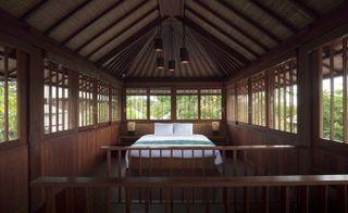 An image of a guest room showing the bed