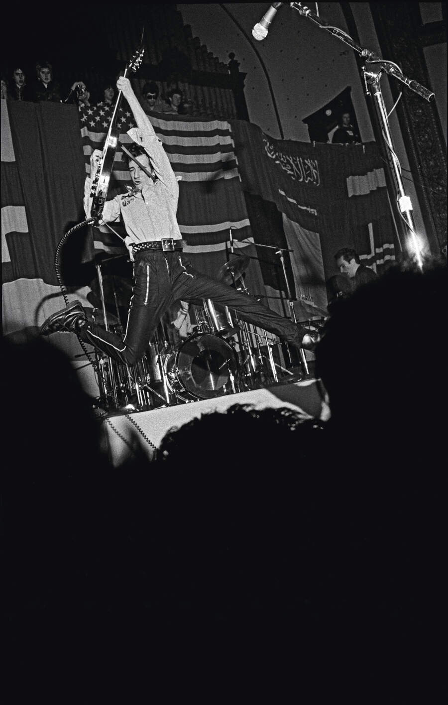 Mick Jones jumps on stage at the Temple Beautiful benefit show in San Francisco, California, US, 8th February 1979.