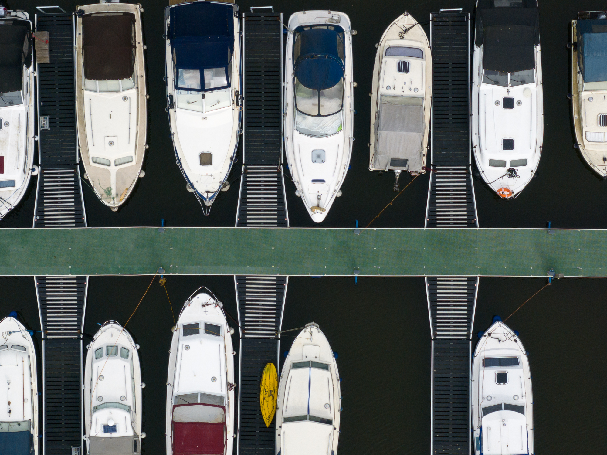 Aerial photo of boats moored to a jetty shot with DJI Mavic 3 Pro 166m telephoto camera
