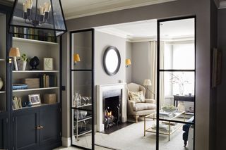 grey living room with Crittall doors by Sims Hilditch