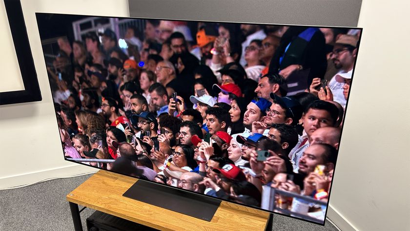 The 65-inch LG G5 OLED TV pictured on a wooden rack. On the screen is a still from Netflix F1 series Drive to Survive.
